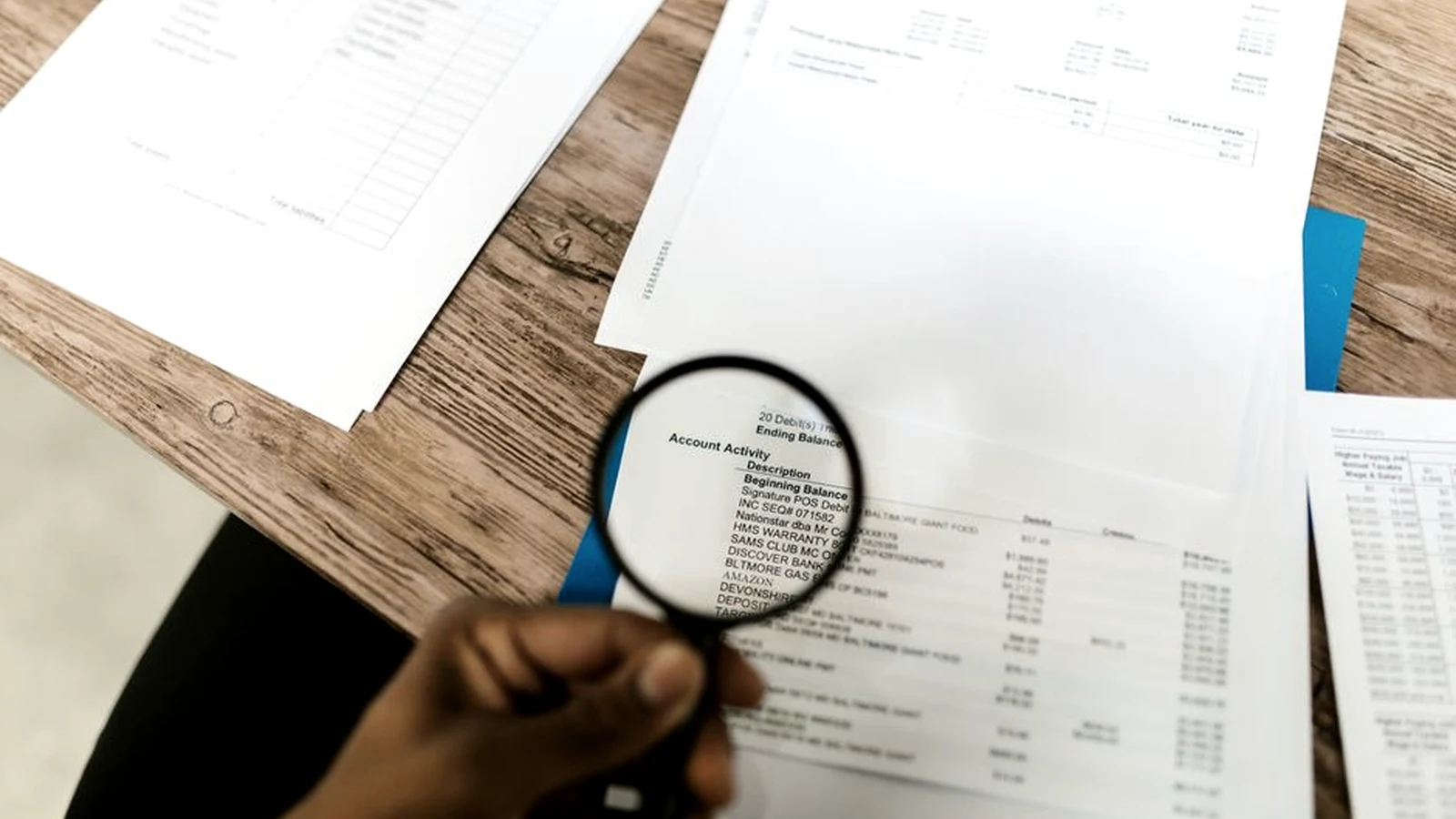 A magnifying glass examining figures in a printed document
