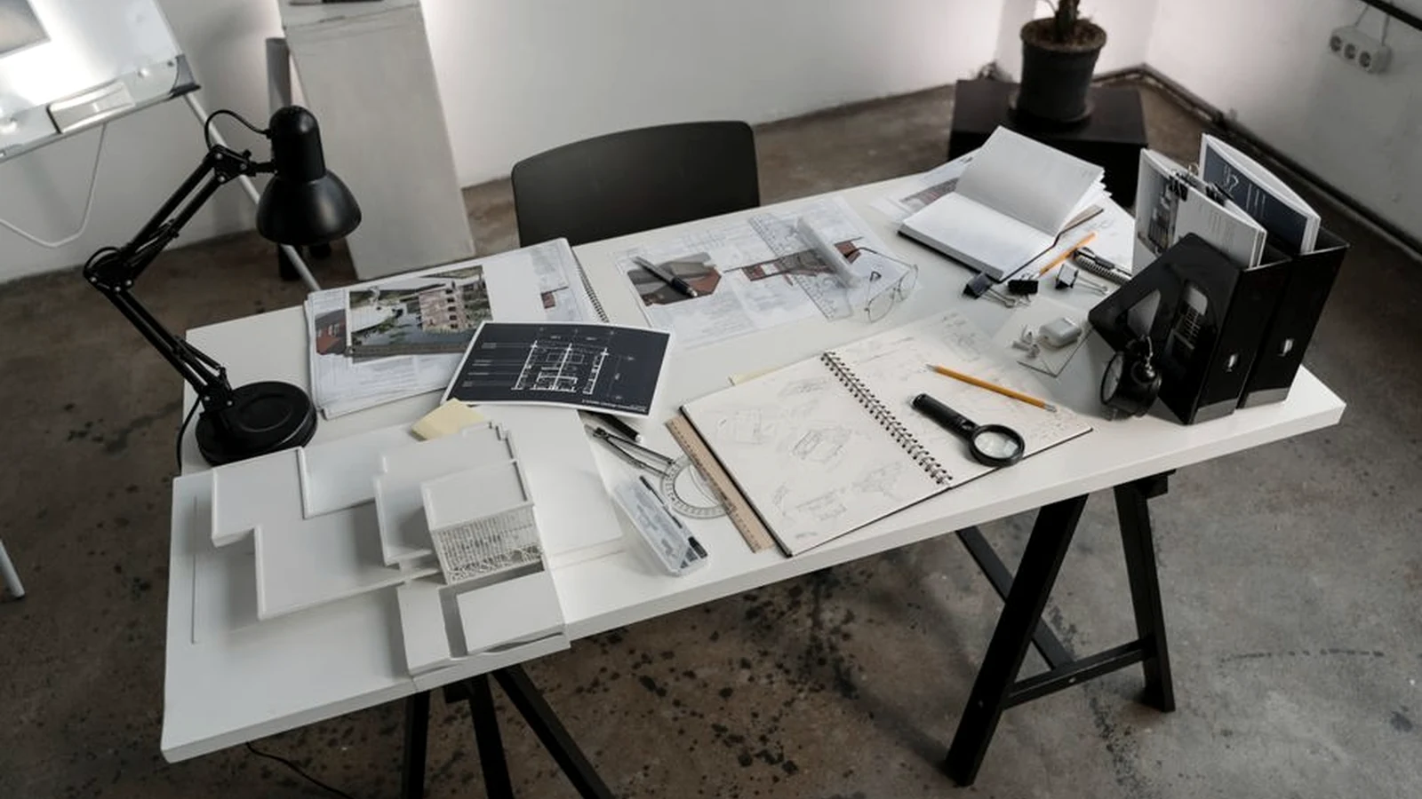 Website migration plans, wireframes and drafting tools arranged on a worktable